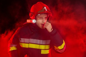 Firefighter in action using a walkie-talkie